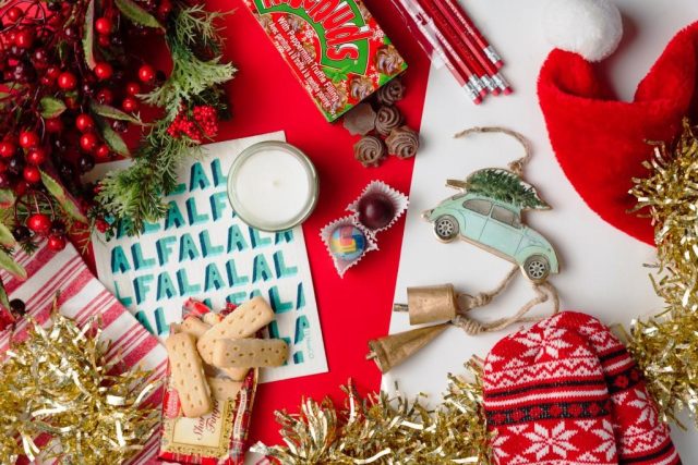 Festive red and white scene, with hats and christmas treats.